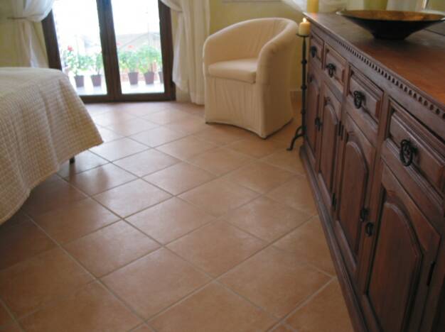 terra cotta floor tiles in master bedroom